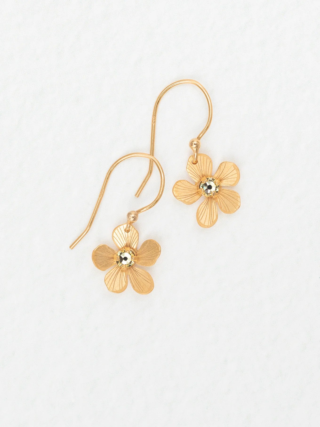 The Plumeria Drop Gold Earrings by Holly Yashi feature textured, flower-shaped petals with a shiny center—feminine jewelry perfect for garden parties. Displayed on a white background.