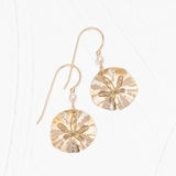 Holly Yashis Gold Sandra Shore Sand Dollar Earrings are 18k gold-filled with small pearl accents. Resting elegantly on a white surface, these hypo-allergenic earrings feature a classic hook for style and comfort.