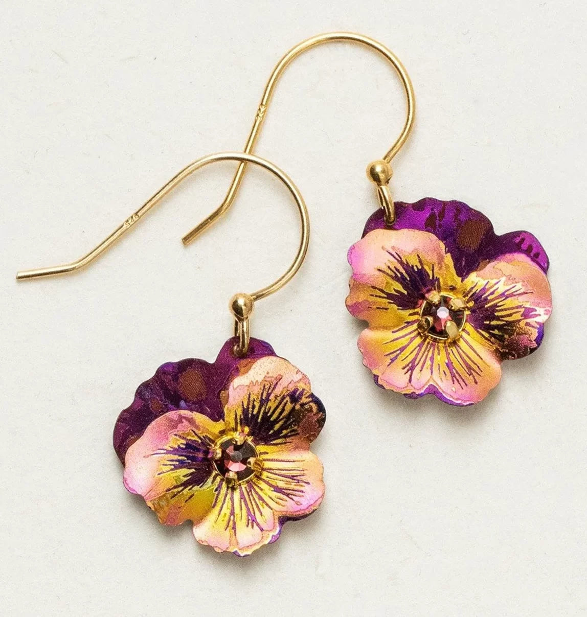 The Vintage Burgundy Garden Pansy Drop Earrings by Holly Yashi feature purple, pink, and yellow flower designs with detailed petals and a central bead. Made of hypo-allergenic niobium, they are perfect for sensitive ears.