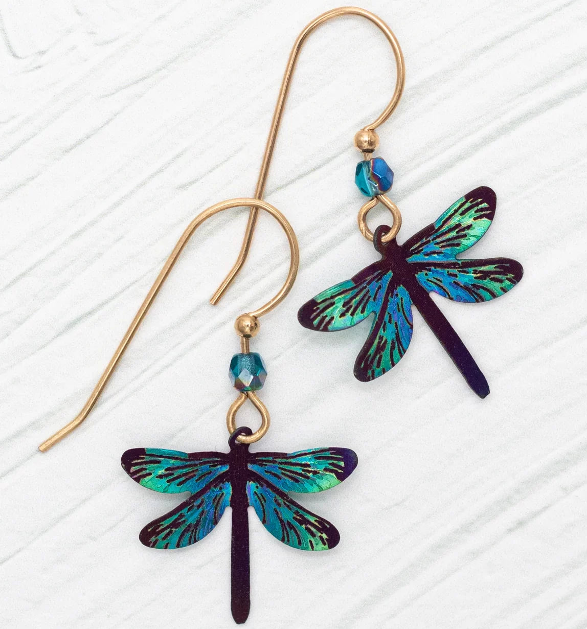 The Turquoise Dragonfly Dreams Earrings by Holly Yashi feature two earrings with colored niobium gold hooks, vibrant teal and blue dragonfly charms, and small blue beads. Designed to be hypo-allergenic for everyone.