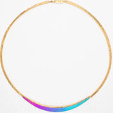 The Gianna Calypso Collar Necklace by Holly Yashi is a thin gold piece with a textured hand-hammered pendant, displaying a stunning purple-to-blue gradient. Hypo-allergenic and elegant, its perfect for sensitive skin.