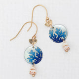 Meet the Coral Reef Seashore Blue Earrings by Holly Yashi: Gold hook earrings featuring blue coral-patterned charms, a beige and brown speckled bead on white, crafted with hypo-allergenic materials for sensitive ears.