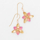 The Special Edition Orla Drops Earrings by Holly Yashi feature gold flower-shaped hooks with pink accents and sparkling Austrian crystals at the center, shown on a plain white background.