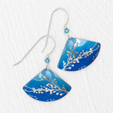 Elegantly experience aquatic beauty with Holly Yashis Sea Meadow Blue and Silver Earrings. These niobium fans feature a leaf pattern, light-to-dark blue gradient, white dots, and delicate blue beads on silver hooks.