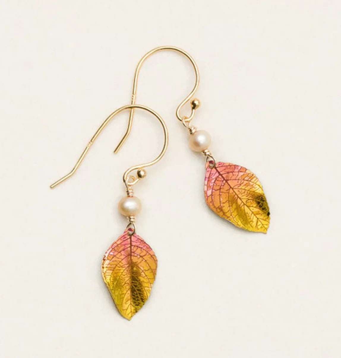 Healing Leaf Peach Earrings by Holly Yashi: These gold hook earrings feature small pearls and pink-yellow leaf-shaped pendants with intricate vein details, crafted from hypoallergenic niobium.