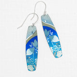 The Malia Kai Blue Earrings by Holly Yashi are long, rectangular handcrafted niobium earrings with silver hooks, featuring blue with white and light blue floral designs and a metallic accent. Hypoallergenic—ideal for sensitive ears.