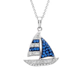 The Shanore Swarovski Crystals Blue Sailing Boat Necklace features a sailboat pendant with blue and clear stones on a sterling silver chain, showcasing elegant striped sails and a sparkling hull.