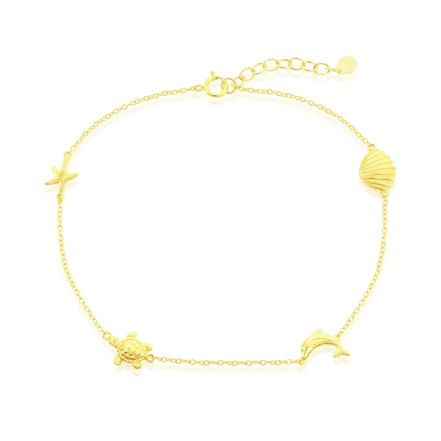 The Classic of New York Gold Plated Shell/Dolphin/Turtle/Starfish Anklet features ocean-inspired charms on a fine adjustable chain, perfect for adding a delicate beach touch to any outfit.