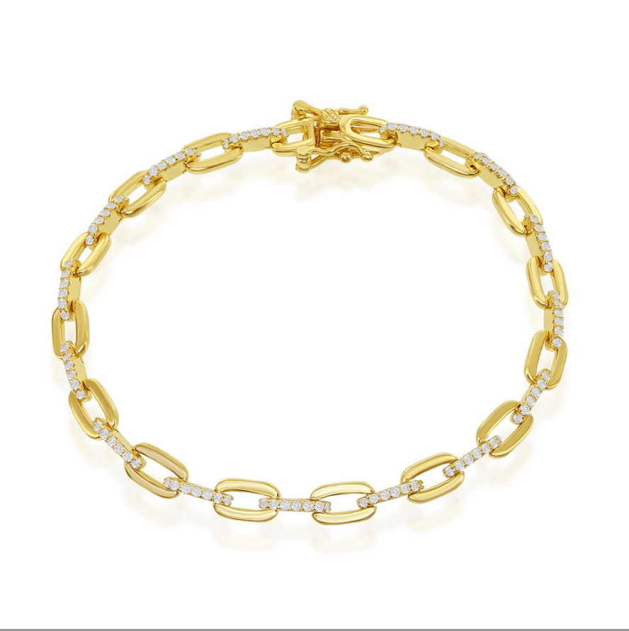 The Classic of New York Gold Plated CZ Paperclip Bracelet, featuring oval links partially set with white CZ stones and a decorative clasp, is displayed on a white background.