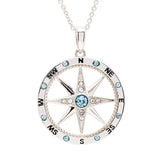 The Shanore Swarovski Crystals Aqua and White Compass Necklace - Ocean Jewelry is a sterling silver pendant adorned with shimmering crystals. It features eight directional points labeled N, NE, E, SE, S, SW, W, NW with blue gems embellishing the points and outer circle for a stunning look.