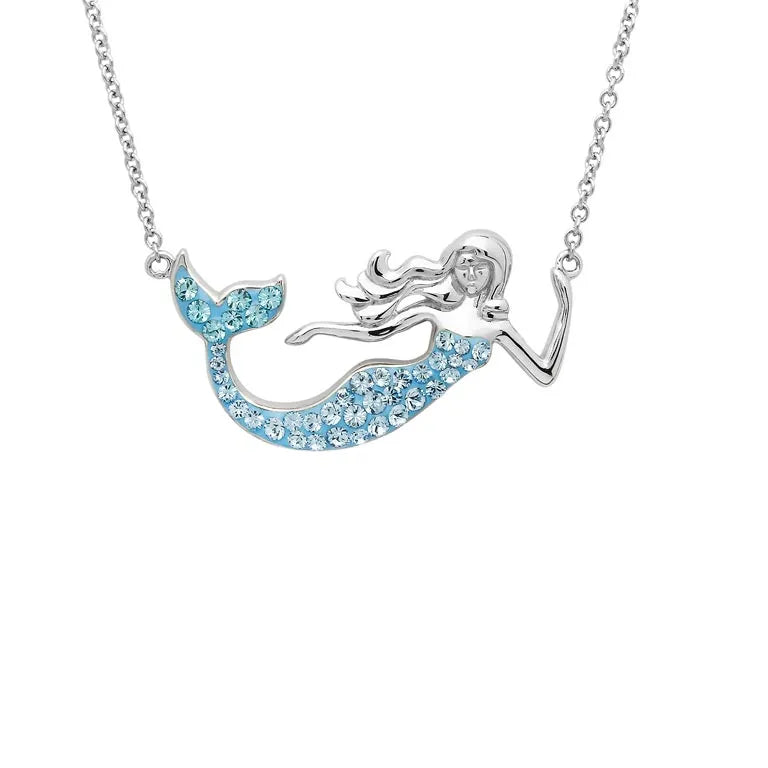 The Swarovski Crystals Aqua Mermaid Necklace-Ocean Jewelry by Shanore features a sterling silver chain and a mermaid pendant. The tail sparkles with blue gemstones, resembling crystals, complementing the intricate mermaid design beautifully.