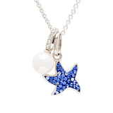 The Shanore Swarovski Crystals Blue Sapphire Pearl Starfish Necklace—Ocean Jewelry elegantly combines a blue, gem-studded starfish with a lustrous white pearl on a delicate chain, enhancing the intricate details of these pendants.
