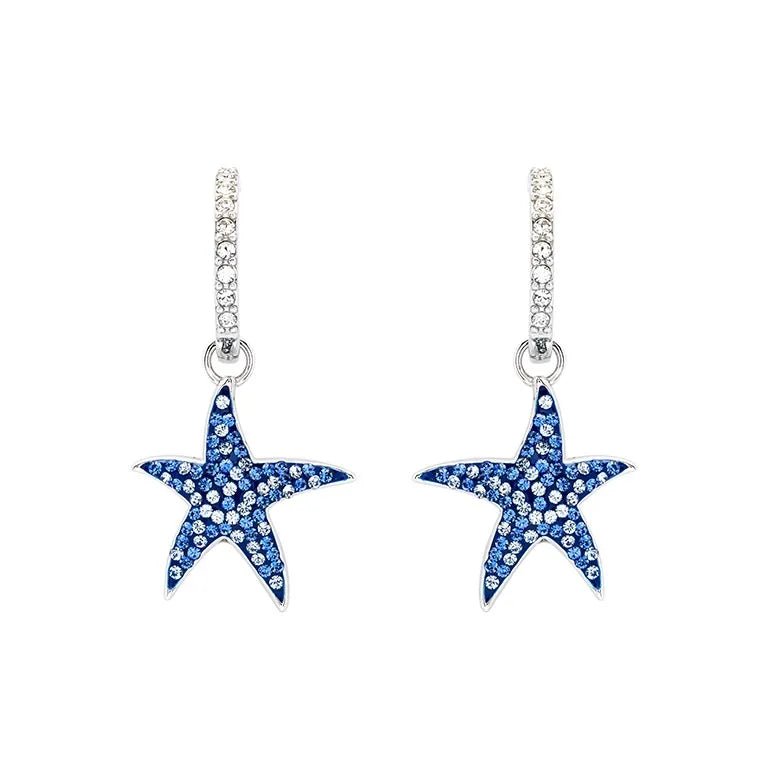 These elegant Shanore earrings are sterling silver hoops with Swarovski crystal and stone-encrusted starfish charms, designed as blue sapphire ocean-inspired jewelry.