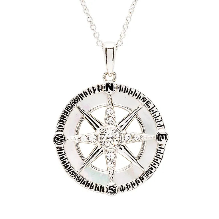 The Swarovski Crystals White Compass Necklace by Shanore features a sterling silver compass pendant with N, S, E, W directions and Follow your dreams engraved around it. The elegant piece is adorned with crystals and suspended on a delicate chain.