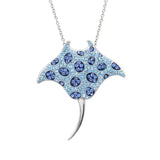 This stunning piece from Shanore, the Swarovski Crystals Blue Stingray Necklace-Ocean Jewelry, boasts a manta ray pendant adorned with blue Swarovski crystals in circular patterns and a gracefully curved tail. It hangs elegantly from a silver chain against a white backdrop.