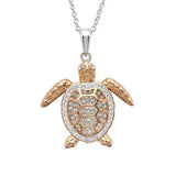 The Shanore Swarovski Crystals Rose Gold Turtle Necklace from Ocean Jewelry features a dazzling turtle pendant with an intricately detailed head and flippers. The shell, adorned with Swarovski crystals, elegantly hangs from a sterling silver chain, making it a stunning addition to any collection.