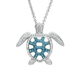 The Shanore Swarovski Crystals Teal Filigree Turtle Necklace features a silver turtle pendant adorned with clear and blue crystals, hanging from a delicate sterling silver chain. The shells blend of stones creates a sparkling effect, making it the perfect Ocean Jewelry piece for any occasion.