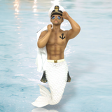 The Anchors Away Ornament by December Diamonds features a shirtless merman with a white tail, sailor hat, sunglasses, and an anchor tattoo. Set against a water backdrop, it makes for unique holiday decor or a whimsical collection piece.
