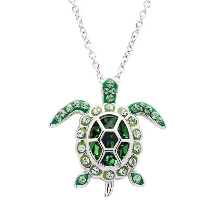 The Shanore Swarovski Crystals August Birthstone Turtle Necklace features a sterling silver turtle pendant with green and black Swarovski crystals, elegantly hanging from a delicate chain, adding sophistication to any outfit.