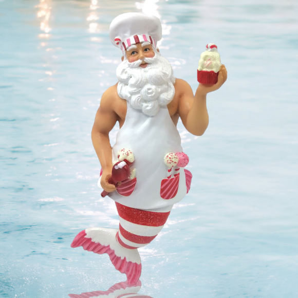 Add sweet charm to your holiday decor with the Baking Santa Ornament by December Diamonds—a whimsical merman chef with a Santa beard, cupcake, ice cream, red-and-white striped tail, chef’s hat, and apron.