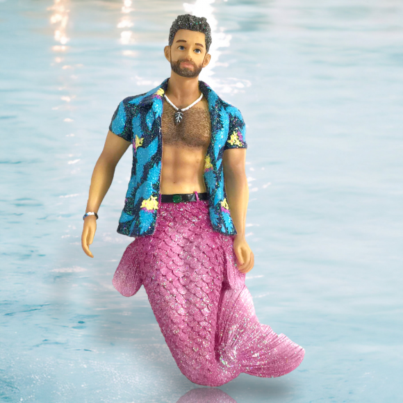 The Beach Bim Bo Ornament by December Diamonds features a bearded merman with a pink mermaid tail and blue floral shirt, set against a water-themed background—perfect for your holiday decor or mermaid collection.