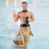 The Champs Ornament by December Diamonds features a merman with a glittery gold tail holding a champagne bottle and glass. Adorned with a black bow tie against a watery backdrop, its an enchanting addition to your mermaid-themed holiday décor collection.