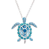 The Shanore Swarovski Crystals March Birthstone Turtle Necklace from the Ocean Jewelry collection features a turtle pendant with blue gemstones, including turquoise and deep blue, beautifully outlining the shell and flippers.