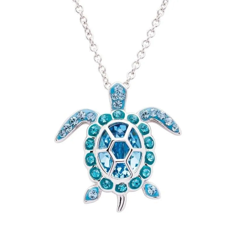 The Shanore Swarovski Crystals March Birthstone Turtle Necklace from the Ocean Jewelry collection features a turtle pendant with blue gemstones, including turquoise and deep blue, beautifully outlining the shell and flippers.