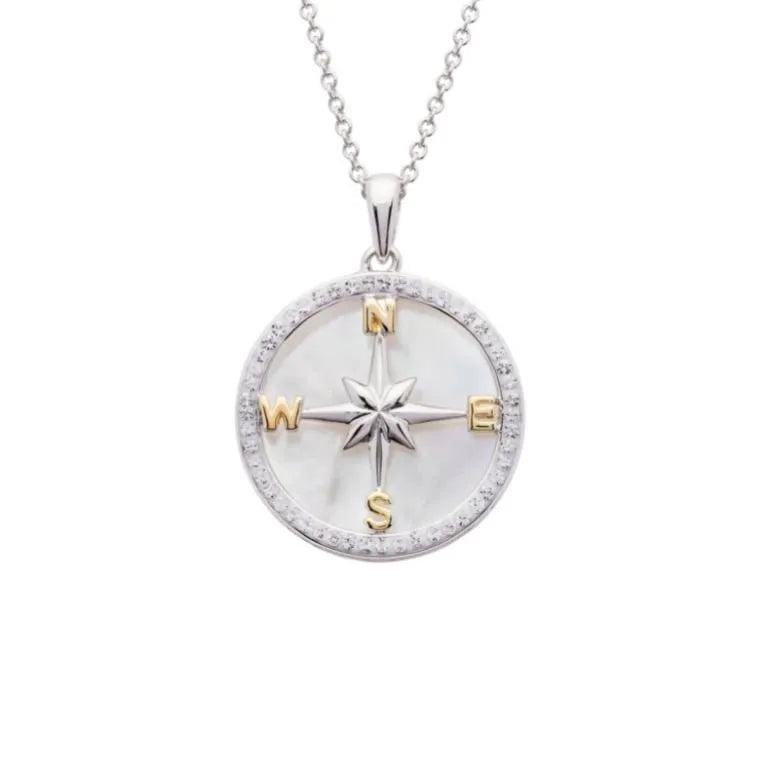 The Shanore Swarovski Crystals Mother of Pearl Compass Necklace features a stunning sterling silver design with a round pendant, central star shape, and gold-toned N, E, S, W letters on pearlescent background, adorned with Swarovski crystals and hanging on a delicate chain.