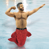 Celebrate the magic of the sea with December Diamonds Muscle Beach II Ornament. This merman features a muscular upper body, shimmering red glittery tail, and superhero pose against a water-like backdrop—a perfect holiday decor addition.