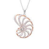 The Swarovski Crystals Nautilus Shell Necklace by Shanore features a captivating pendant, expertly crafted in rose gold and sterling silver. Its dazzling Swarovski crystals hang elegantly on a delicate chain, creating an enchanting ocean-inspired piece.