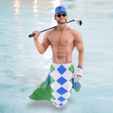 A smiling, muscular man with sunglasses, a blue cap, and a golf glove flaunts his colorful merman tail ornament. He holds a golf club over his shoulder in light blue water, embodying the whimsical charm of December Diamonds Putt Sinker Ornament holiday decor.