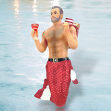 The Santa Daddy Ornament by December Diamonds is perfect for holiday decor, featuring a kneeling merman on ice with a red and white sparkly tail, holding a wine glass and candy cane. With his gray beard, short hair, and belt with a large buckle, he seems straight out of hand-painted Merman ornaments.