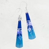 The Midnight Blue Tula Earrings by Holly Yashi Jewelry feature a blue gradient with silver hooks and floral designs. Adorned with decorative dots, theyre hypo-allergenic and set against a textured surface, enhanced by elegant 18k gold-filled accents.