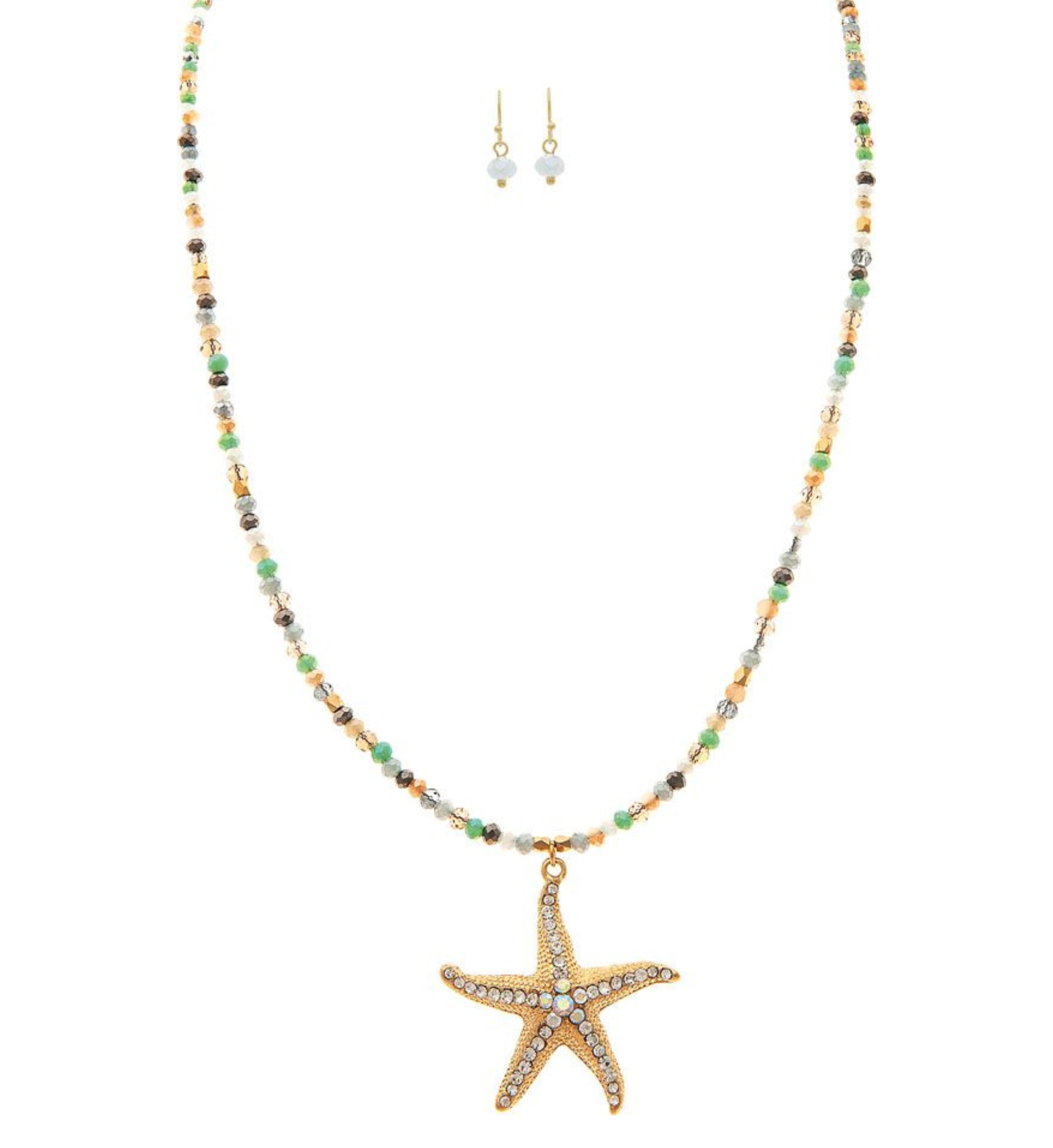 The A-Train Gold Cry Starfish Beaded Cord Necklace Set includes a sparkling starfish necklace and small pearl earrings—perfect for special occasions, shown on a white background.