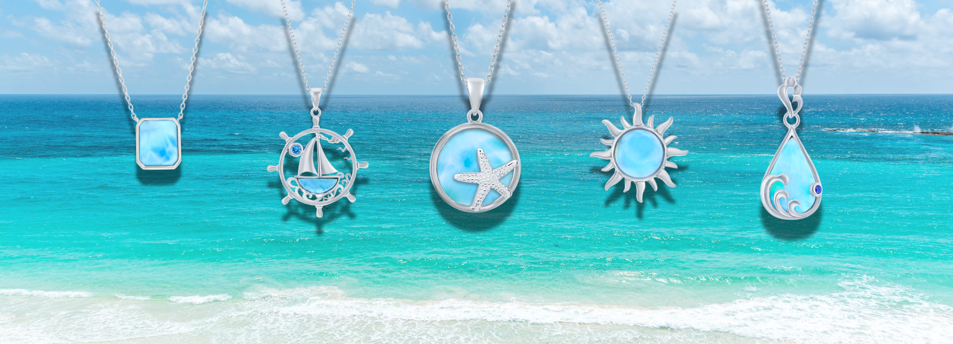 Five silver necklaces with ocean-themed pendants, including a square, sailboat, starfish, sun, and teardrop, are displayed against a bright blue ocean and sky background.