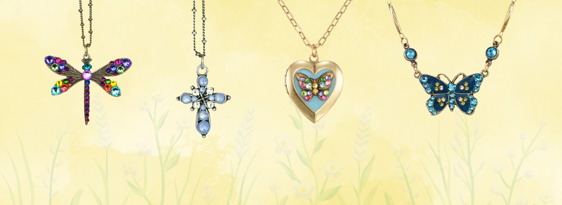 Five ornate necklaces with jeweled pendants: a compass, a colorful dragonfly, a lavender heart, a pink flamingo, and a blue dragonfly.