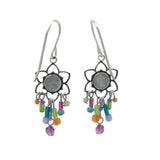 Fireflys Light Medium Flower Multi-Color Earrings feature handmade silver flower shapes with circular centers. Each petal has a dangling thread adorned with colorful beads in purple, green, blue, orange, and pink. Crafted using fair-trade practices for ethically stylish wear from Firefly Jewelry.