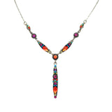 Handmade in Guatemala by Firefly Jewelry, the Linear “Y” Multi-Color Necklace features vibrant red, purple, green, and orange gemstones set in silver on a delicate chain. It showcases fair-trade practices and an ornate design.