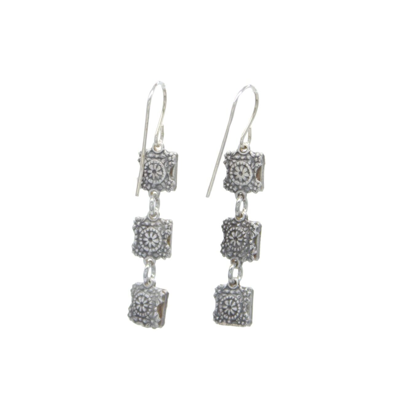 The Rainbow Square Multi-Color Earrings by Firefly feature three vertically linked silver squares engraved with intricate floral patterns, hanging elegantly from simple hooks. These fair-trade handmade earrings offer a unique and stylish design for art enthusiasts.