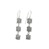 The Rainbow Square Multi-Color Earrings by Firefly feature three vertically linked silver squares engraved with intricate floral patterns, hanging elegantly from simple hooks. These fair-trade handmade earrings offer a unique and stylish design for art enthusiasts.