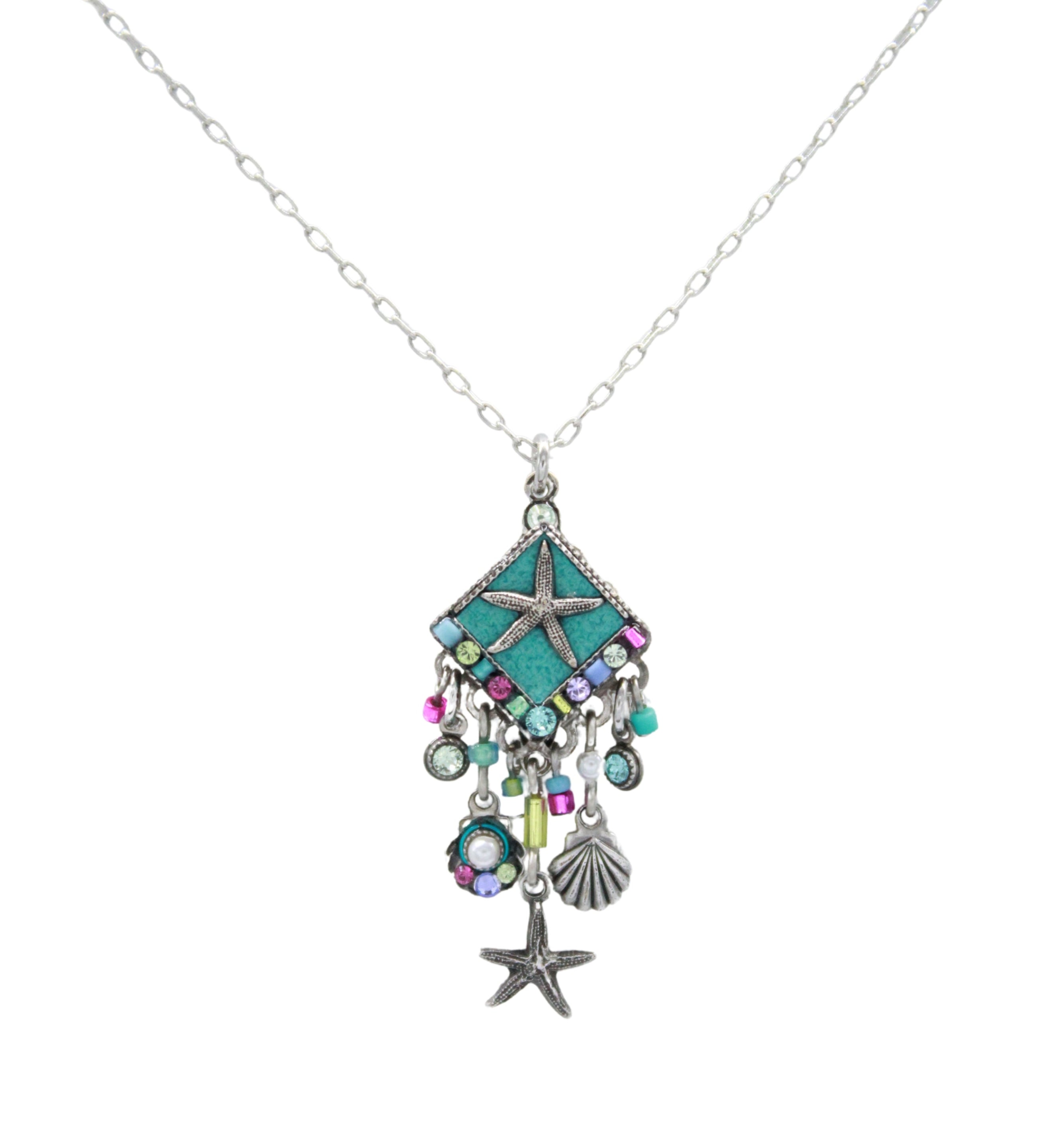 The Firefly Playa Starfish Fringe Soft Necklace features a silver chain with a turquoise diamond pendant, starfish, and playful purple, green, and blue charms. Beautifully handmade in Guatemala by Firefly Jewelry.