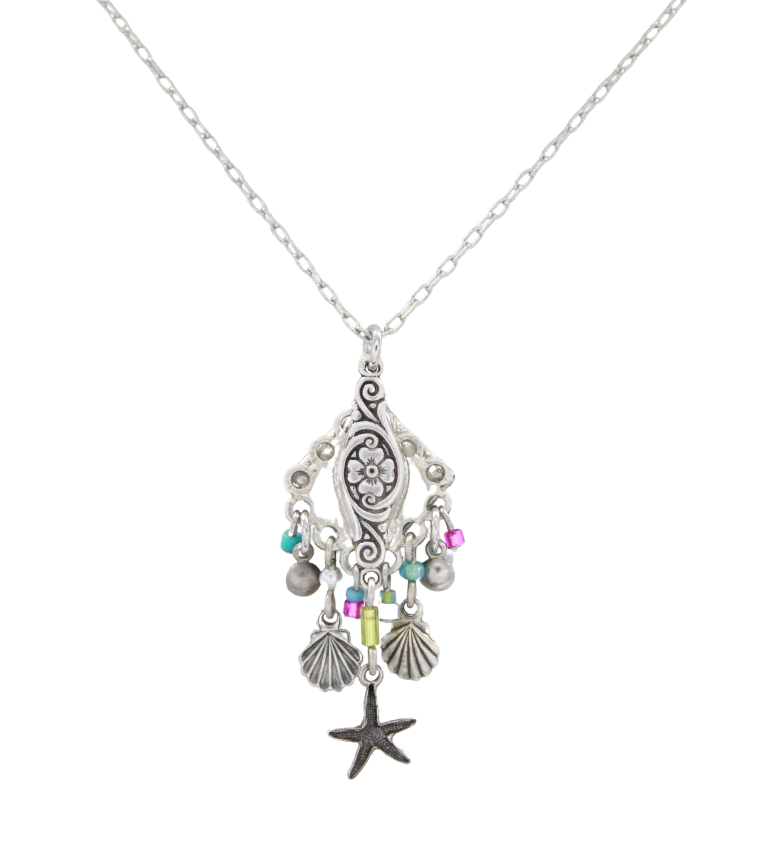 The Playa Starfish Fringe Soft Necklace by Firefly is a handmade silver necklace from Guatemala, featuring a detailed floral pendant with starfish, seashell charms, and pink, turquoise, and green beads for a playful look.