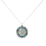 The Playa Sand Dollar Soft Necklace by Firefly features a silver round sand dollar pendant accented with blue, green, and pink gemstones. This handmade Firefly Jewelry piece adds the perfect touch to any ensemble.