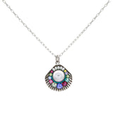 The Firefly Beach Pearl Large Shell Soft Necklace features a silver chain with a fan-shaped pendant, a central white stone, and colorful gems. Handmade in Guatemala, this fair-trade piece is set against a white background.