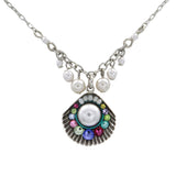 The Beach Pearl Large Shell Fringe Soft Necklace by Firefly features a central seashell pendant with a large pearl, colorful gemstones, and five pearl charms. Handmade in Guatemala for an elegant, coastal look.