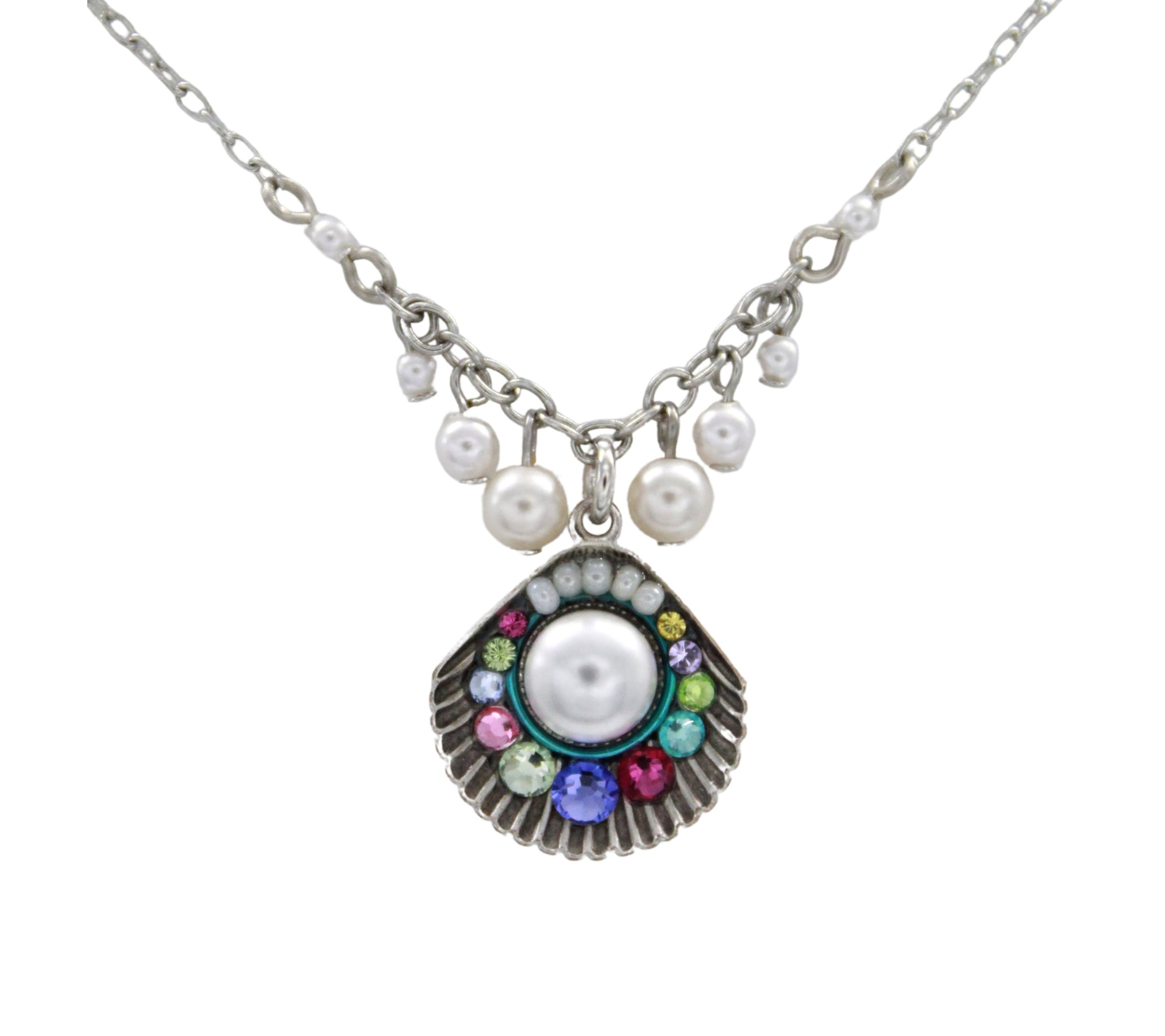 The Beach Pearl Large Shell Fringe Soft Necklace by Firefly features a central seashell pendant with a large pearl, colorful gemstones, and five pearl charms. Handmade in Guatemala for an elegant, coastal look.