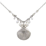 The Firefly Beach Pearl Large Shell Fringe Soft Necklace features a central shell pendant with white pearls and beads, displayed on a plain white background. Handmade in Guatemala for the Firefly Jewelry collection.