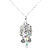 The Beach Pearl Diamond Shell w/Fringe Soft Necklace by Firefly features handmade Guatemalan craftsmanship with a floral pendant, purple, green, and turquoise beads, plus silver shell and sphere charms.