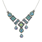 The Ocean Elaborate Soft Necklace by Firefly is a handmade silver piece from Guatemala, featuring colorful square and round pendants with star, heart, and swirl designs plus three gemstone dangles for a whimsical geometric accent.